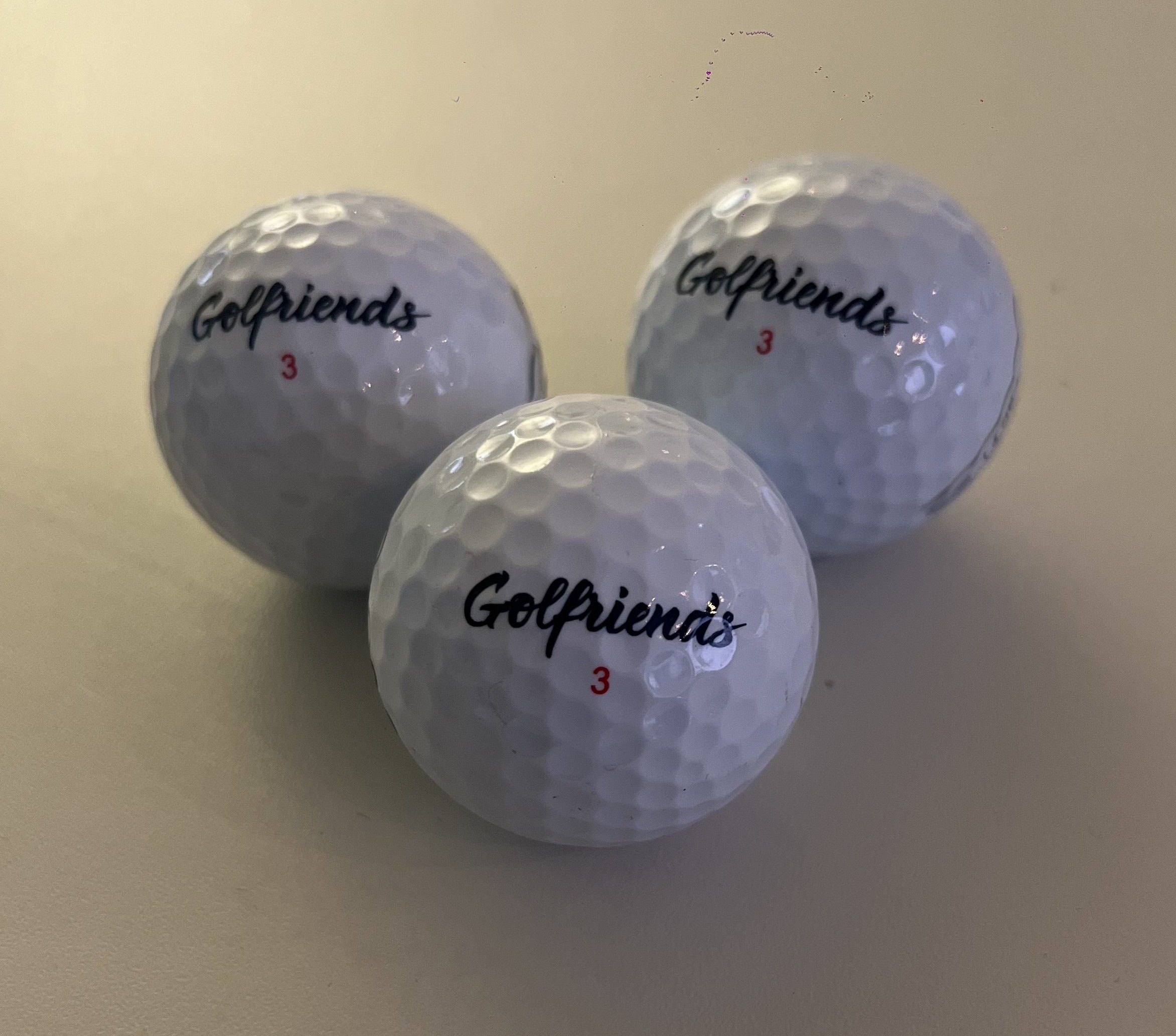 Golfriends branded golf ball with aerodynamic dimple pattern